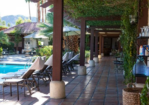 A tiled covered walkway that goes by the pool at La Maison Hotel in Palm Springs, California