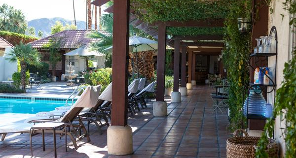 A tiled covered walkway that goes by the pool at La Maison Hotel in Palm Springs, California