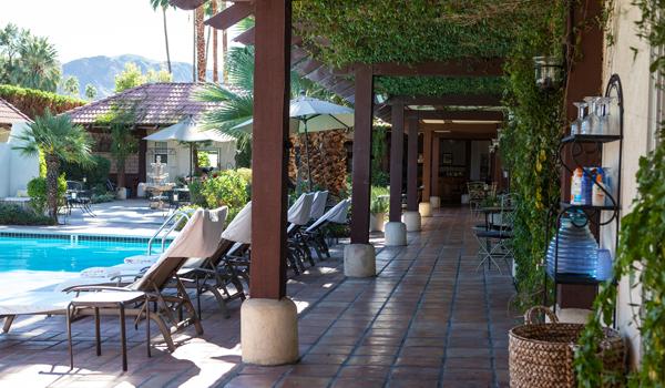 A tiled covered walkway that goes by the pool at La Maison Hotel in Palm Springs, California