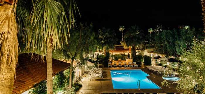 Alcazar Palm Springs’ outdoor pool, patio, and terrace at night