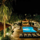 Alcazar Palm Springs’ outdoor pool, patio, and terrace at night