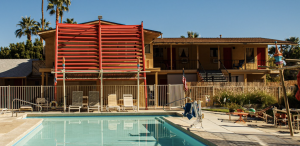 An orange awning above the patio next to the pool at the retro Aloha Hotel in Palm Springs, California