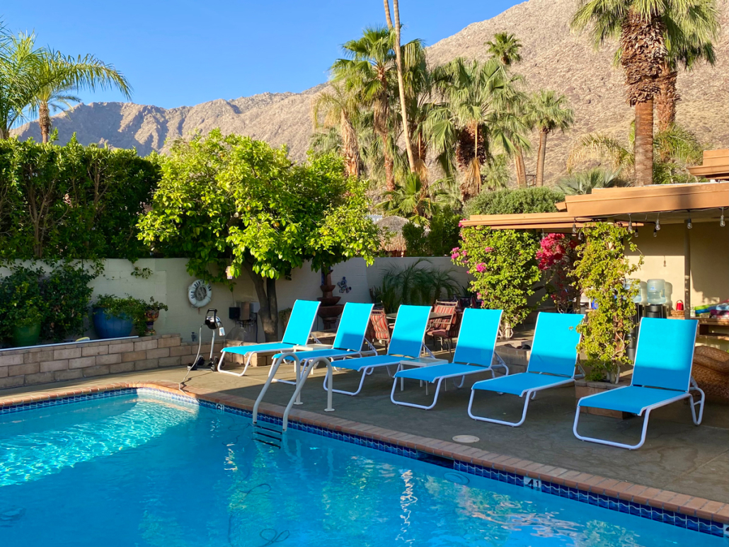 The pool at Old Ranch Inn with blue chairs around it