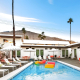 Two colorful rafts float in the courtyard pool on a sunny day at The Wesley Palm Springs hotel