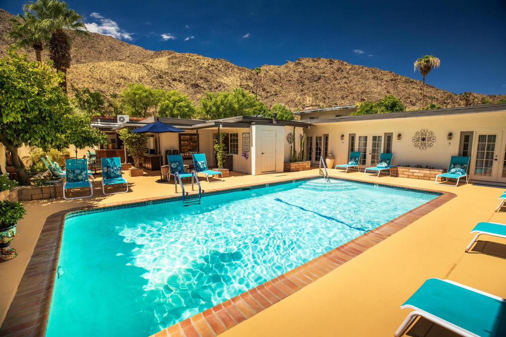 The pool surrounded by lounge chairs at Old Ranch Inn in Palm Springs, California