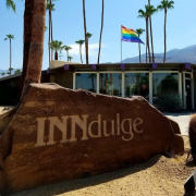 A rock sign that says INNdulge in front of INNdulge Palm Springs gay men's clothing-optional resort in Palm Springs, California