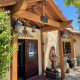 The front entrance to Old Ranch Inn in Palm Springs has a fountain and wood beams