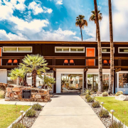 The stone front of Del Marcos Hotel with orange doors