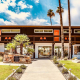 The stone front of Del Marcos Hotel with orange doors