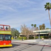 A tour bus drives down a street in Palm Springs during Modernism Week