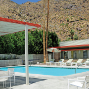 The mid-century modern Orbit In's pool surrounded by white lounge chairs in Palm Springs