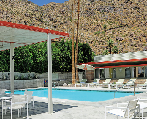 The Orbit In's retro pool surrounded by loungers and vintage umbrellas