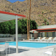 The Orbit In's retro pool surrounded by loungers and vintage umbrellas