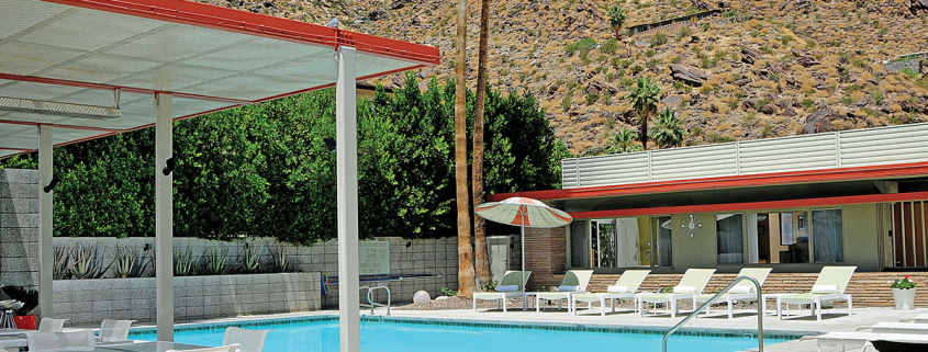 The mid-century modern Orbit In's pool surrounded by white lounge chairs in Palm Springs