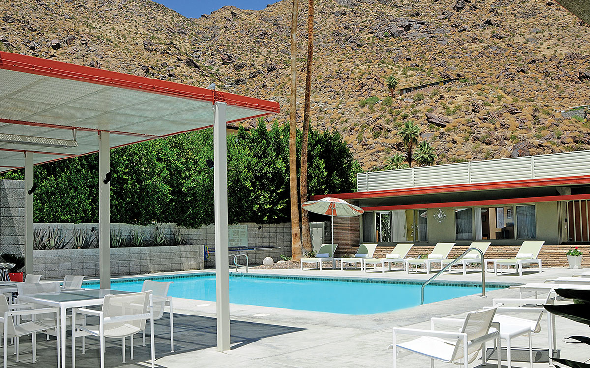 The Orbit In's retro pool surrounded by loungers and vintage umbrellas
