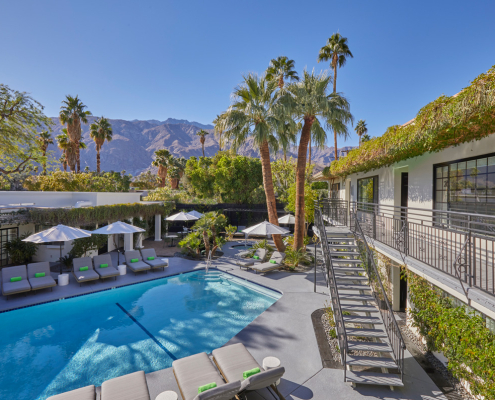 A staircase leads guests up to the second floor of comfortable poolside rooms at the Descanso Resort in Palm Springs, California