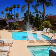 The Triangle Inn pool and spa on a bright sunny day in Palm Springs, California