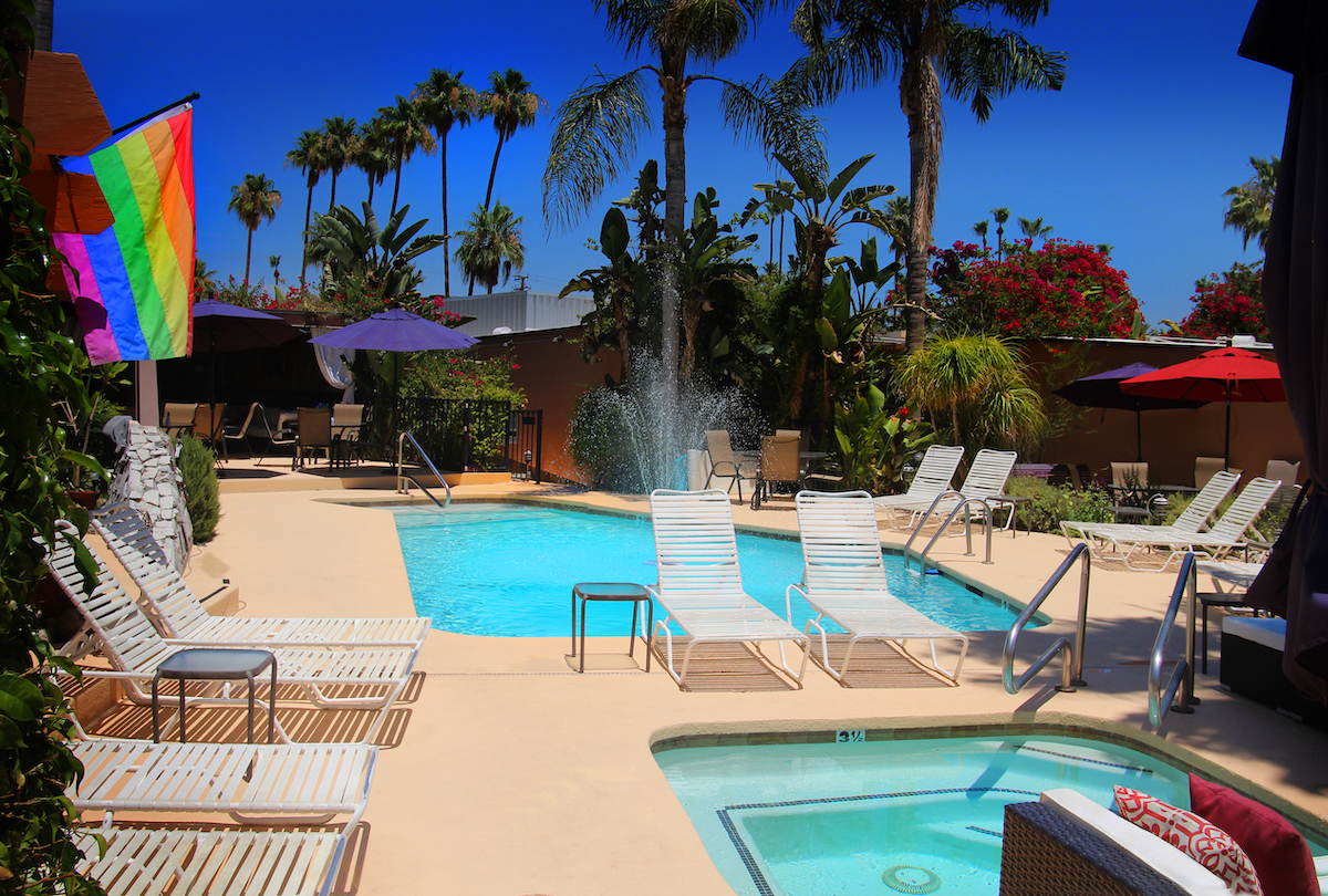 The Triangle Inn pool and spa on a bright sunny day in Palm Springs, California