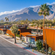 An aerial view of the mid-century architecture of Arrive Palm Springs with the San Jacinto Mountains in the background