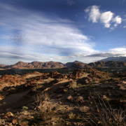 A desert landscape with blue skies and puffy clouds