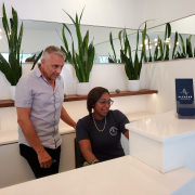 A man and a woman behind the front desk at Alcazar Palm Springs look at a computer