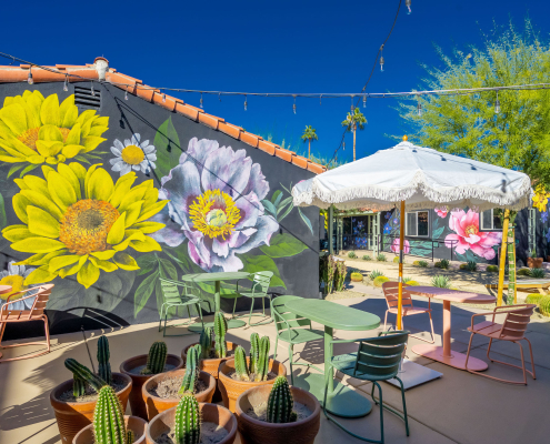 A giant mural of yellow and blue flowers at Fleur Noire Hotel in Palm Springs, California