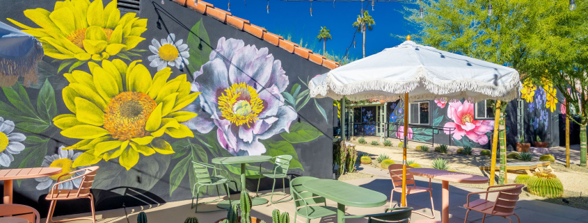 A giant mural of yellow and blue flowers at Fleur Noire Hotel in Palm Springs, California