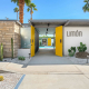 The yellow door at the front entrance to Limón Palm Springs