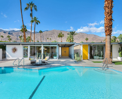 The huge sparkling pool in the back of Limón Palm Springs boutique hotel in Palm Springs, California