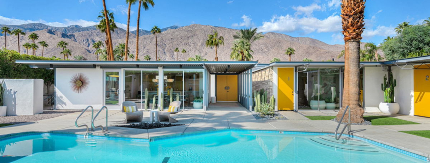 The huge sparkling pool in the back of Limón Palm Springs boutique hotel in Palm Springs, California