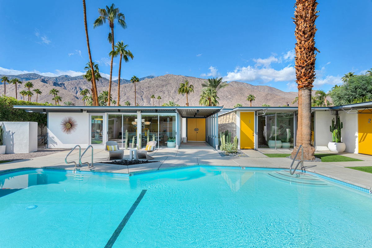 The huge sparkling pool in the back of Limón Palm Springs boutique hotel in Palm Springs, California