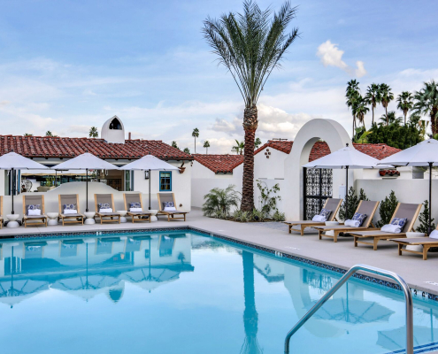 The pool at La Serena Villas in Palm Springs, California, is surrounded by lounge chairs and palms