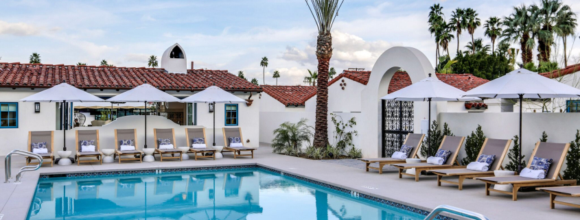 The pool at La Serena Villas in Palm Springs, California, is surrounded by lounge chairs and palms