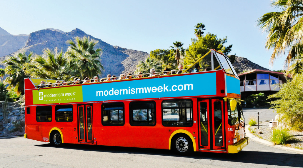 A red double-decker bus takes visitors around Palm Springs, California, during Modernism Week