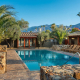 Rocky ledges and palms surround the beautiful pool at Sparrows Lodge Hotel in Palm Springs, California