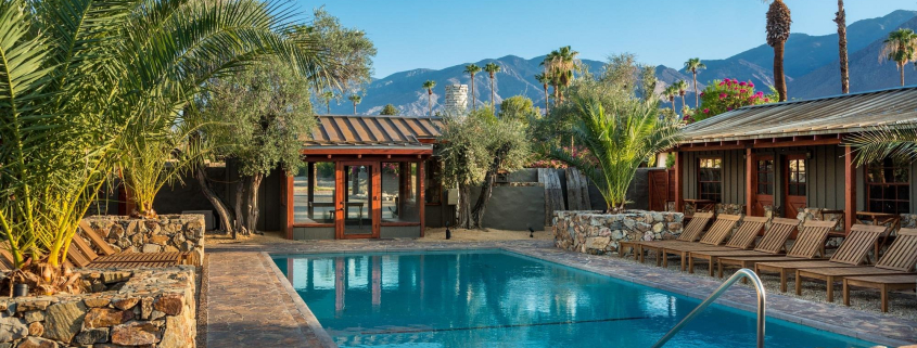 Rocky ledges and palms surround the beautiful pool at Sparrows Lodge Hotel in Palm Springs, California