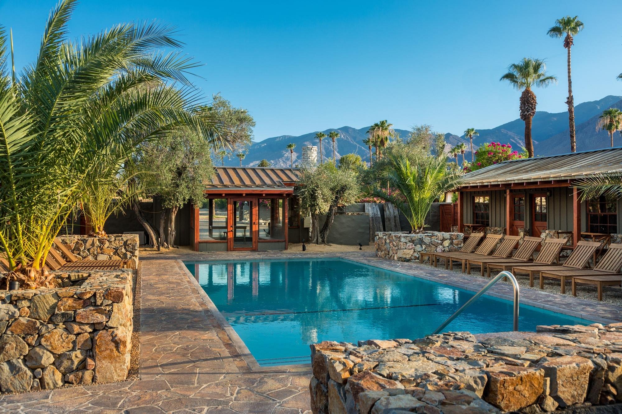 Rocky ledges and palms surround the beautiful pool at Sparrows Lodge Hotel in Palm Springs, California