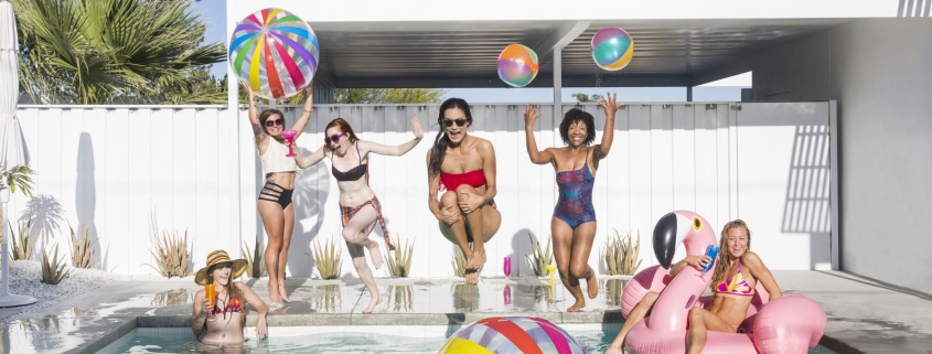 A group of women jumping into a swimming pool