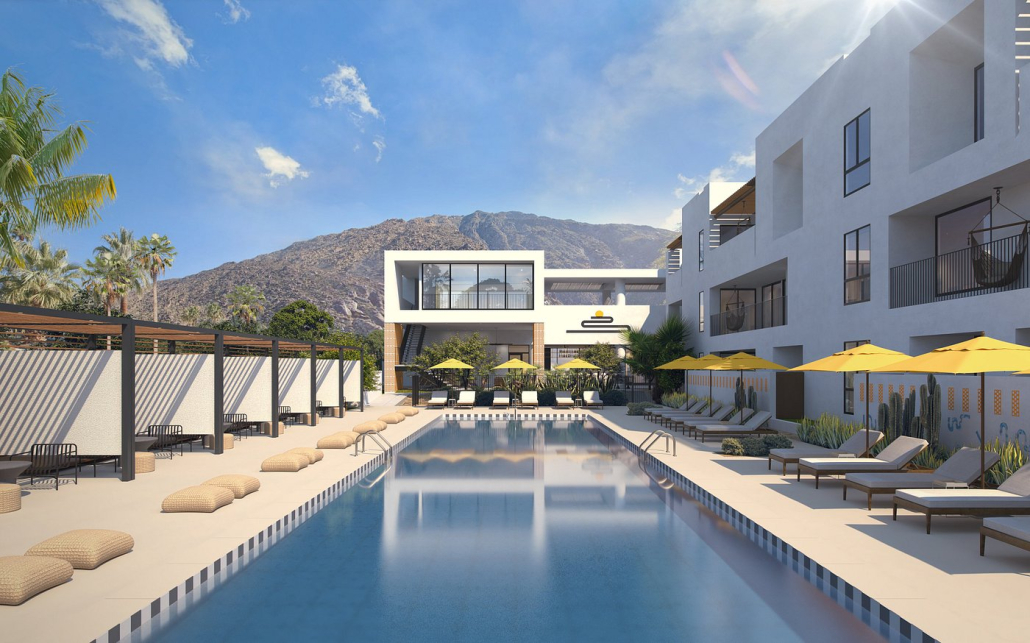 The pool at Drift Palm Springs surrounded by lounge chairs with the hotel's building in the background