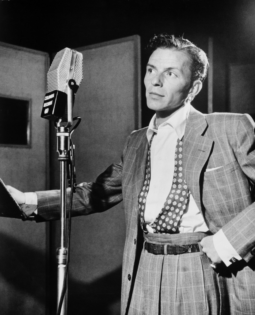Frank Sinatra standing next to a microphone