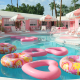 Pink heart shaped floats in the kidney-shaped pool at the Trixie Motel in Palm Springs, California