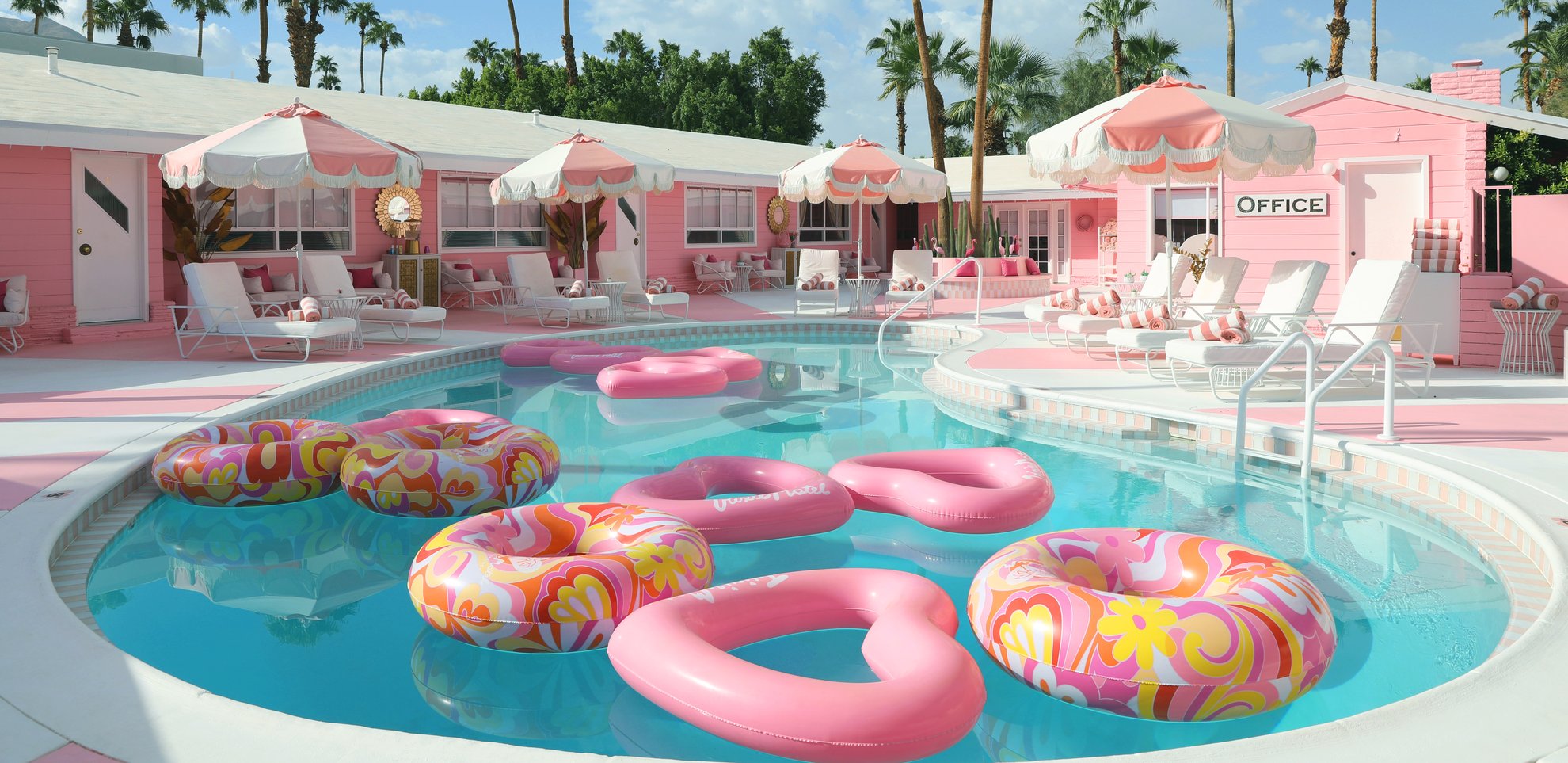 Pink heart shaped floats in the kidney-shaped pool at the Trixie Motel in Palm Springs, California