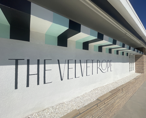 The striped front wall of The Velvet Rope hotel in Palm Springs, California