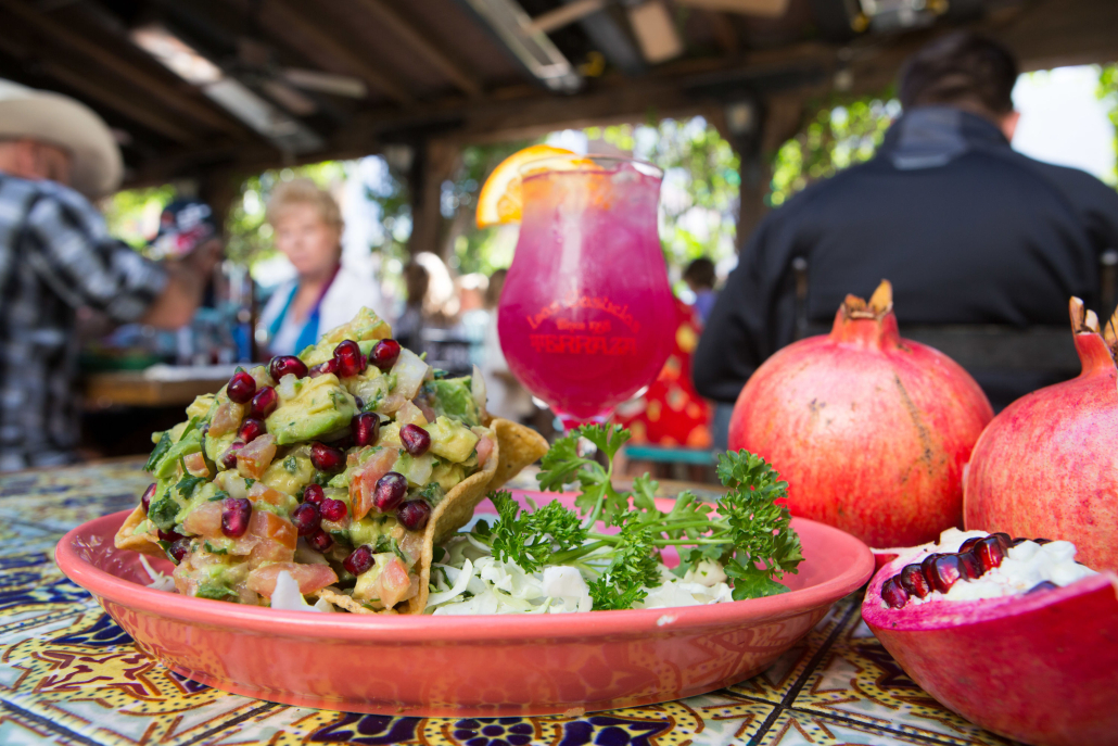 A red plate filled with rice and tacos and a pink margarita from Las Casuelas Terraza in Palm Springs, California