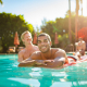 A Black man and a white blonde man in the pool at Santiago Resort in Palm Springs, California