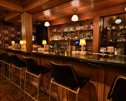 The bar at the Del Rey with liquor bottles on the glass shelves