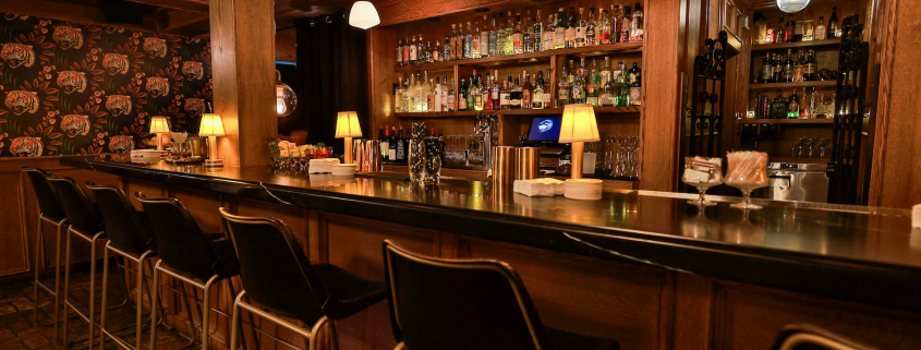 The bar at the Del Rey with liquor bottles on the glass shelves