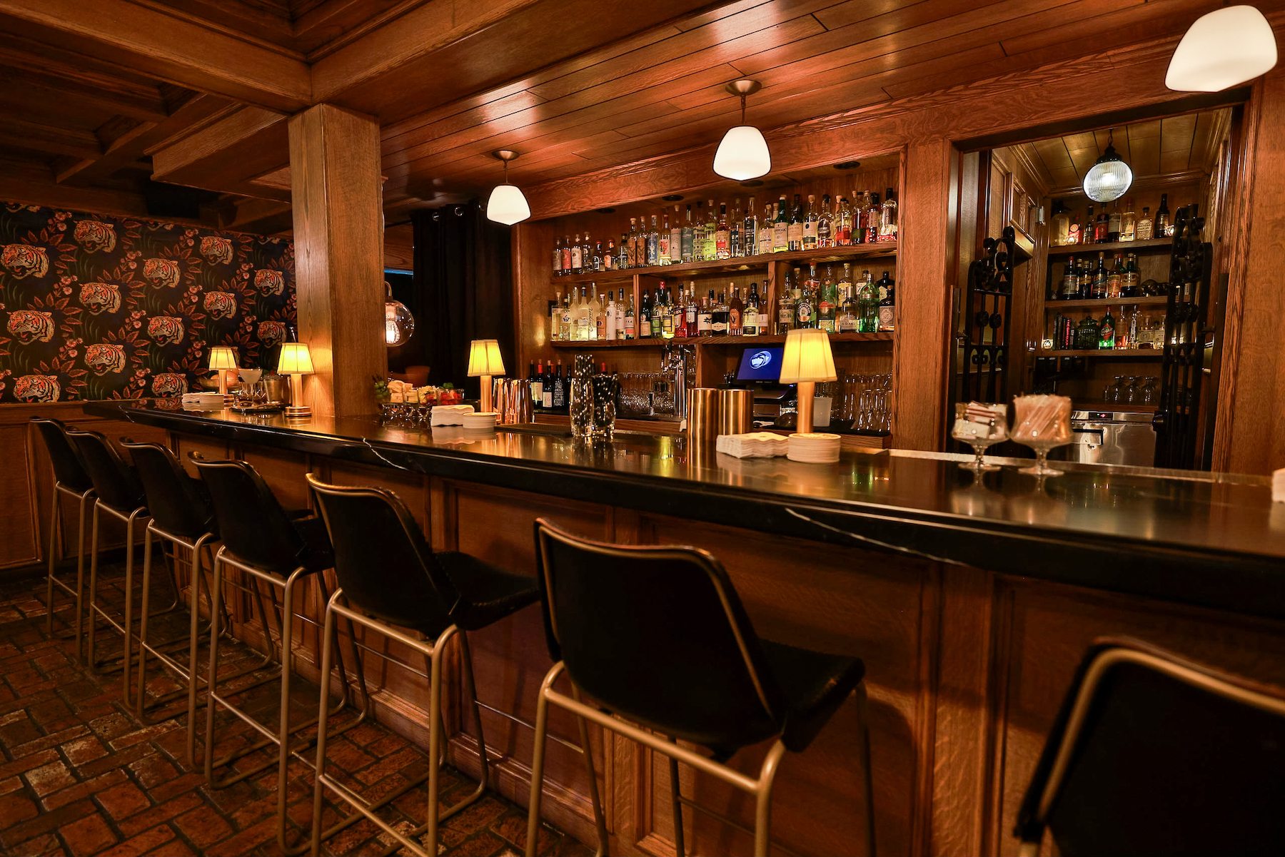 The bar at the Del Rey with liquor bottles on the glass shelves