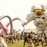 Coachella visitors next to a giant astronaut sculpture