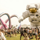Coachella visitors next to a giant astronaut sculpture